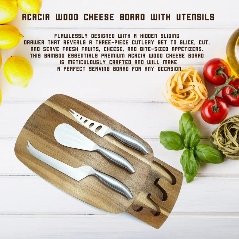 Acacia wood cheese board with three stainless steel serving utensils displayed on white surface, engraved with sample initial "S" on handle, surrounded by fresh lemons, tomatoes, pasta, and basil.
